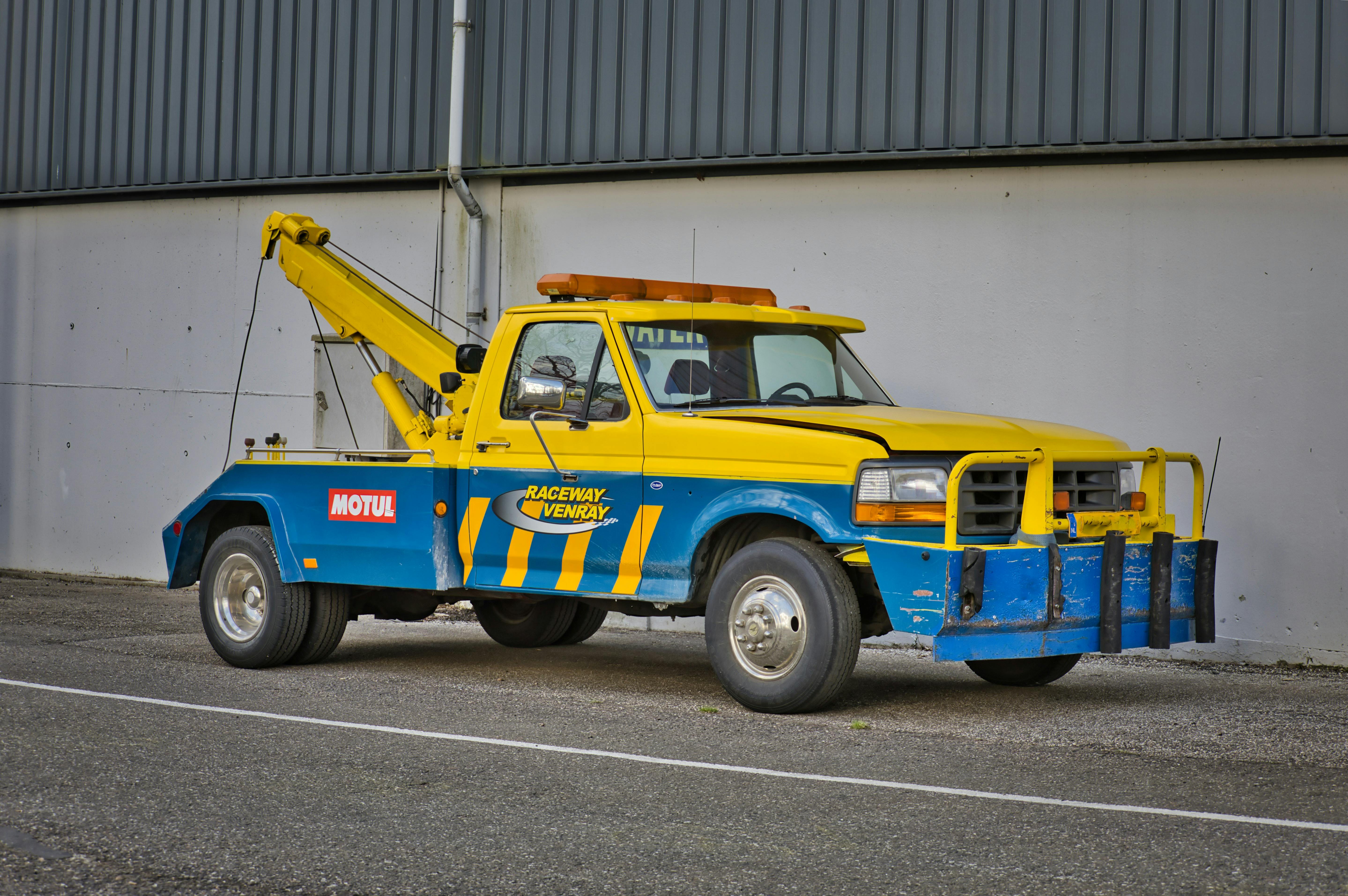 Professional yellow and blue tow truck ready for emergency roadside assistance